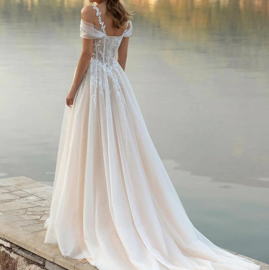 Off-shoulder lace corset wedding dress with full gathered tulle skirt and train