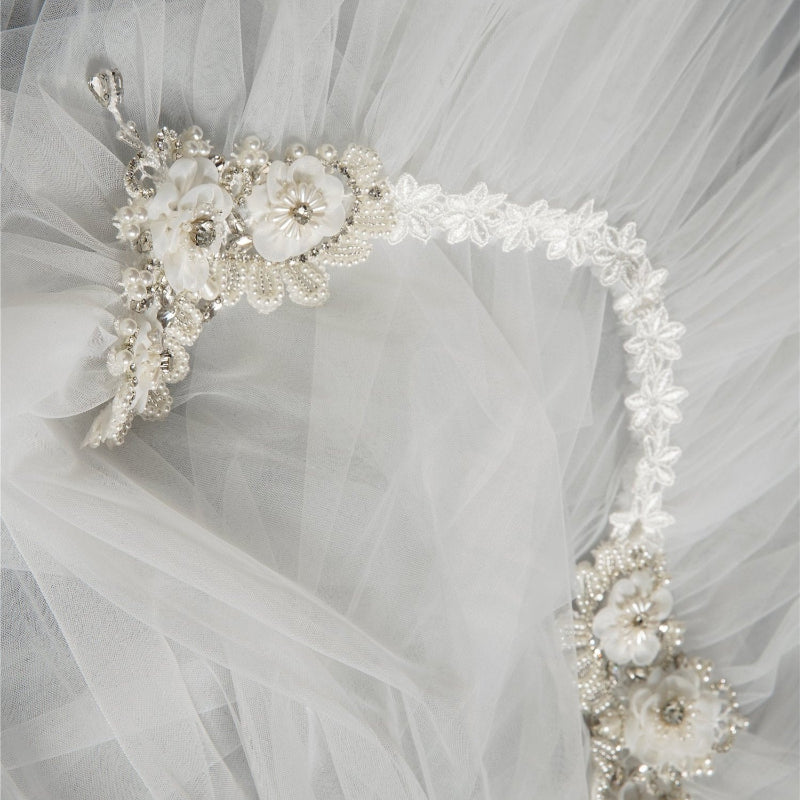 Cape veil detail with pearl-and-crystal floral trim on sheer tulle
