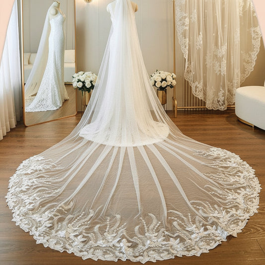 Ivory single-tier cathedral veil with floral lace border and flowing pleated tulle edge