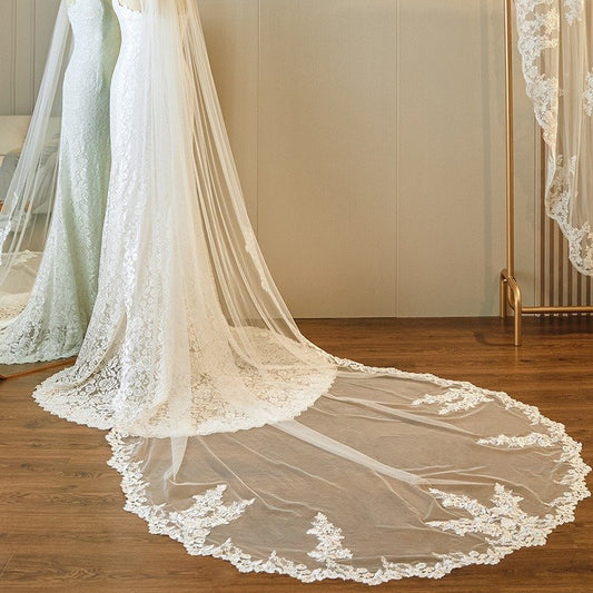 Ivory lace-edged wedding veil, single-tier cathedral length with extended hem