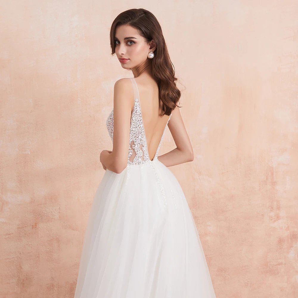 White V-neck tulle formal gown with low back, sleeveless beaded bodice, and full skirt