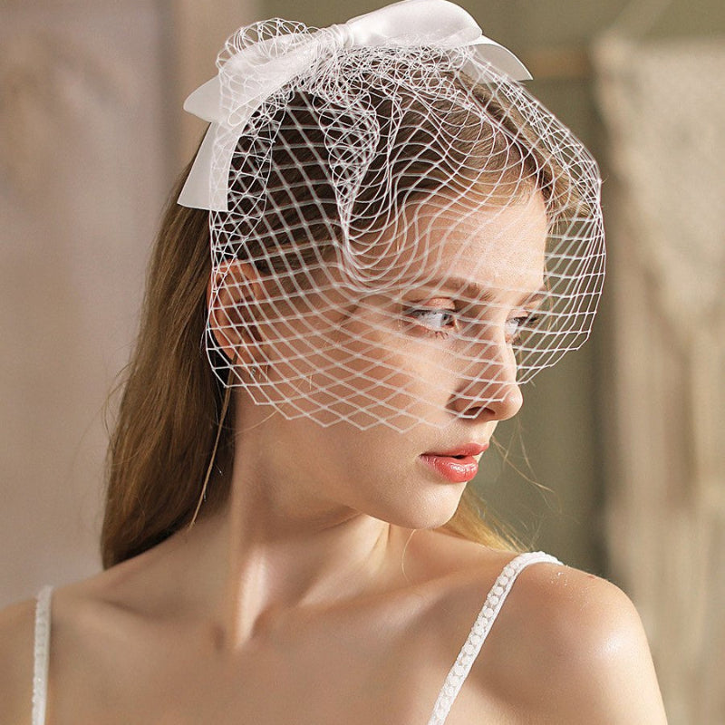 White birdcage veil headband with sweeping side netting and satin bow