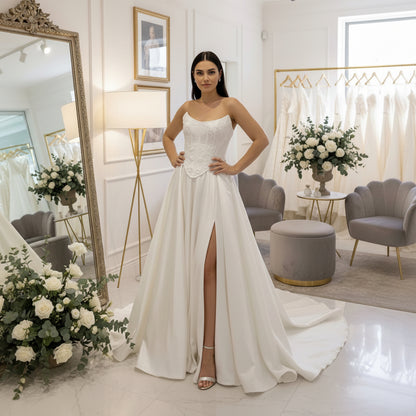 White A-line satin bridal dress with lace bodice and full skirt with front slit