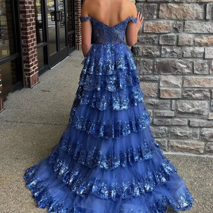 Blue off-shoulder corset-style lace formal gown with glittery tiered skirt and backless detail