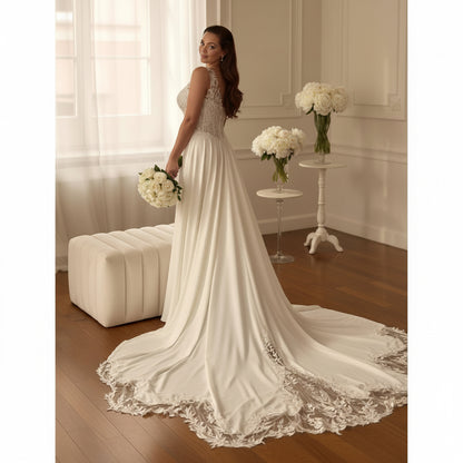 Ivory A-line wedding dress with V-neck lace top, flowing skirt, and lace train hem