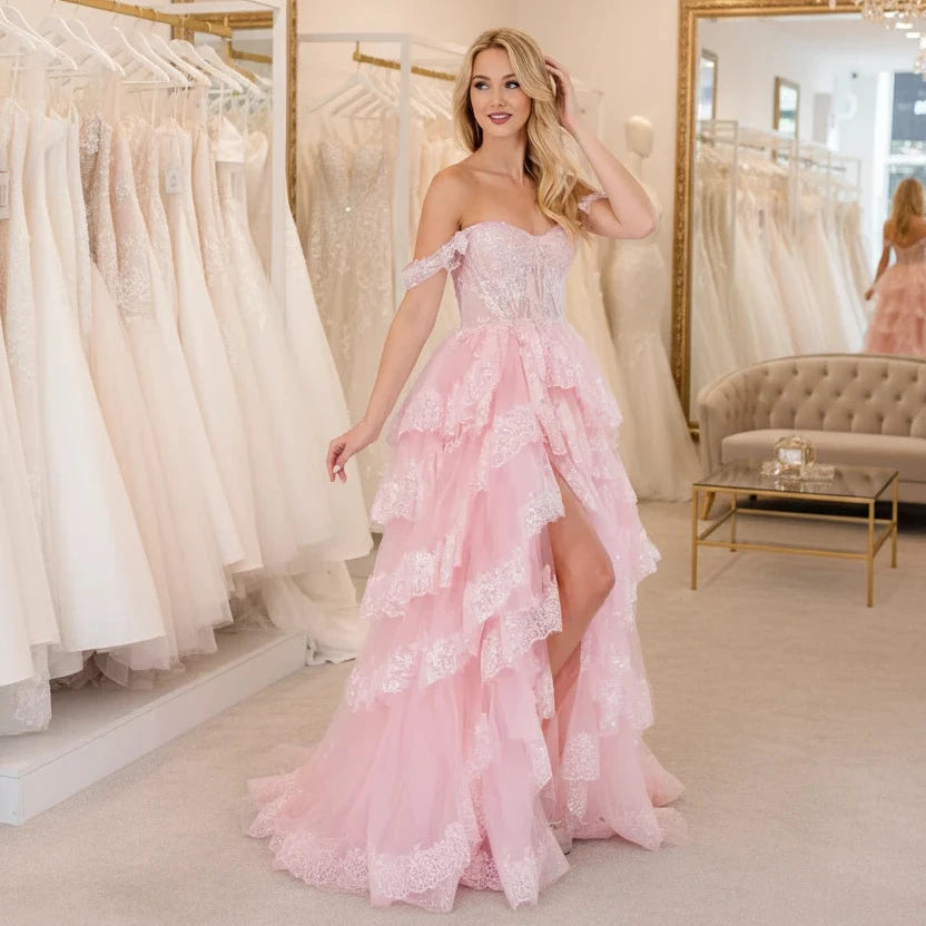 Light pink lace formal gown with sweetheart neckline and layered ruffle skirt