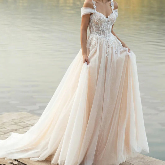 Ivory lace corset wedding dress with off-shoulder neckline and flowing tulle skirt