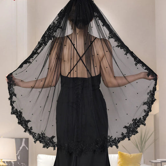 Black short wedding veil with lace edge and pearl-like dot details, draped over shoulders