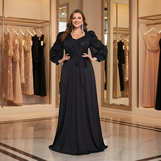 Plus size black V-neck long-sleeve evening dress with sparkly bodice and tied waist