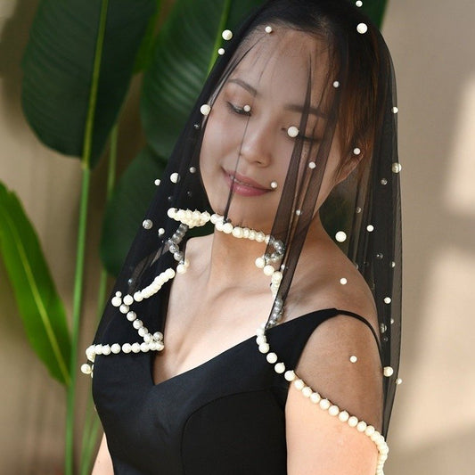 Black short veil with pearl trim and bead accents, draped over shoulders