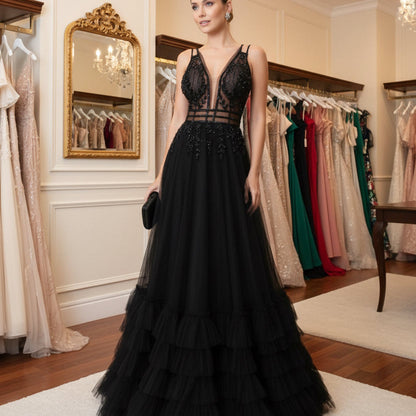 Black A-line evening dress with lace appliques, strappy sheer neckline, full tiered ruffles