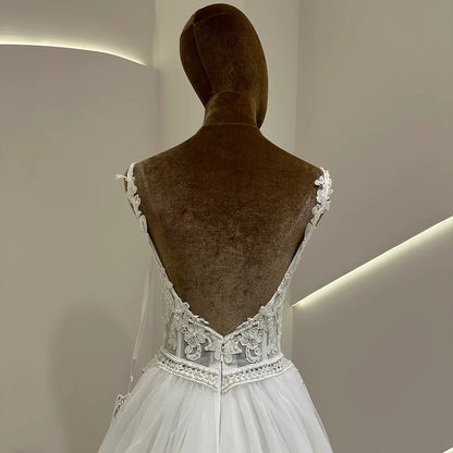 Ivory wedding dress with V-shaped lace back straps and embroidered waist on tulle bodice