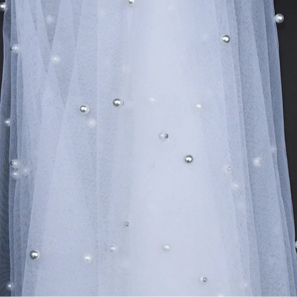 Sheer voile bridal shawl with scattered pearl beads on the mesh