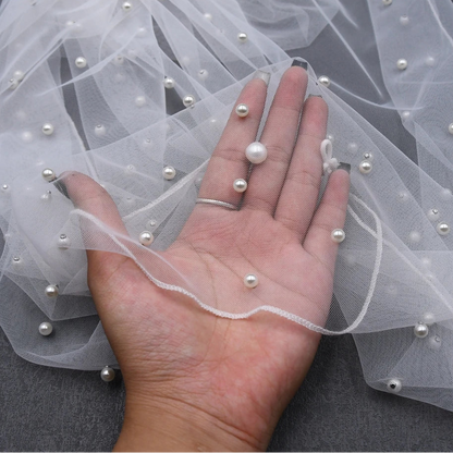 Sheer pearl-beaded bridal shawl edge with delicate beaded string details