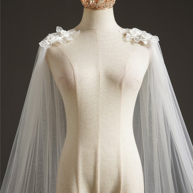 Bridal cape veil with lace appliques at the shoulders and sheer tulle drape