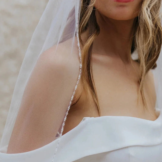 Bridal veil closeup with pearl-like crystal bead trim along the edge