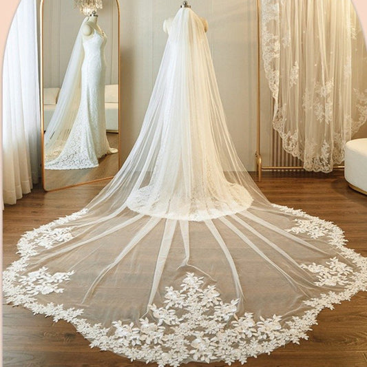 Ivory cathedral veil petal-shaped with lace floral border along the hem, wide drape