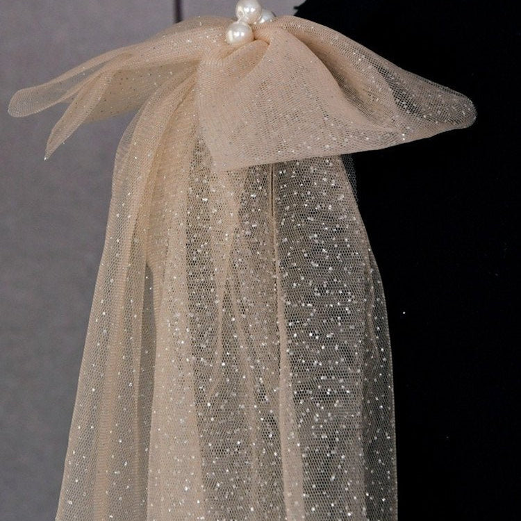 Champagne glitter tulle shoulder bow with pearl cluster and sparkling mesh layers