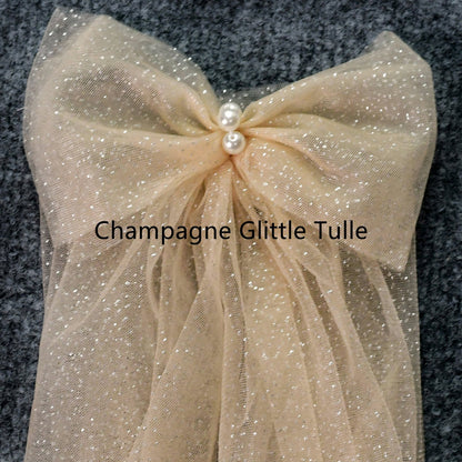 Champagne glitter tulle shoulder bow with gathered fabric and pearl center