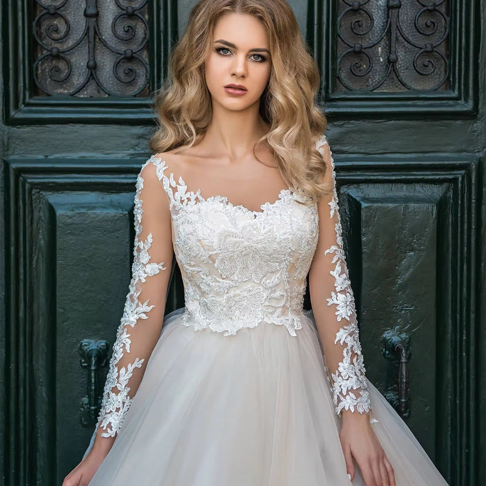 White illusion lace wedding dress with square neckline, floral lace bodice and long sheer sleeves