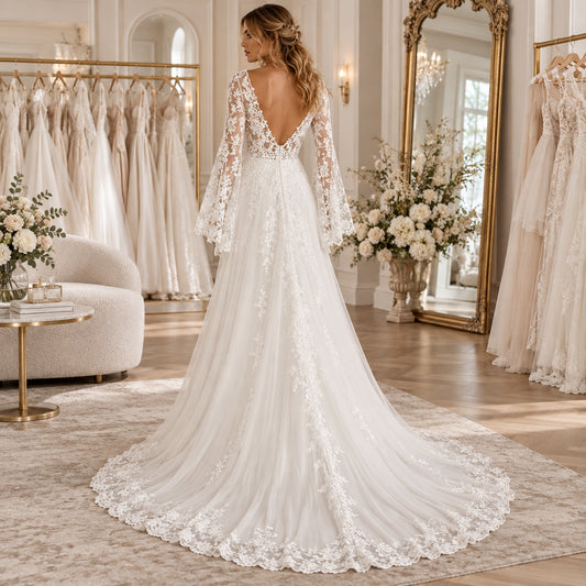 A-line wedding dress with lace appliques, sheer long sleeves, open back, and chapel train