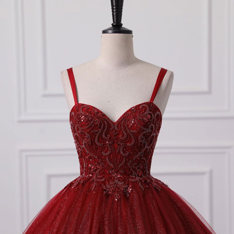 Red lace corset-style bodice ball gown with shimmering tulle skirt