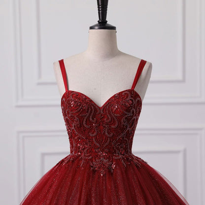 Red lace corset-style bodice ball gown with shimmering tulle skirt