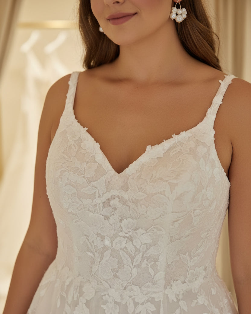 Ivory bridal gown with V-neck, sequined lace bodice, and tulle sleeves