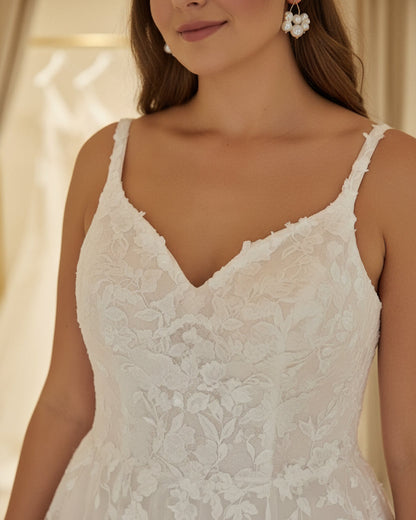 Ivory bridal gown with V-neck, sequined lace bodice, and tulle sleeves