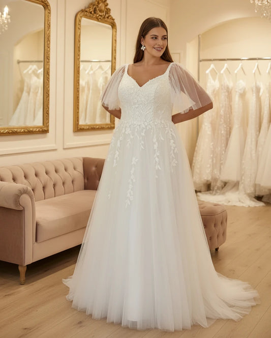Ivory bridal gown with V-neck, sequined bodice, and detachable tulle sleeves