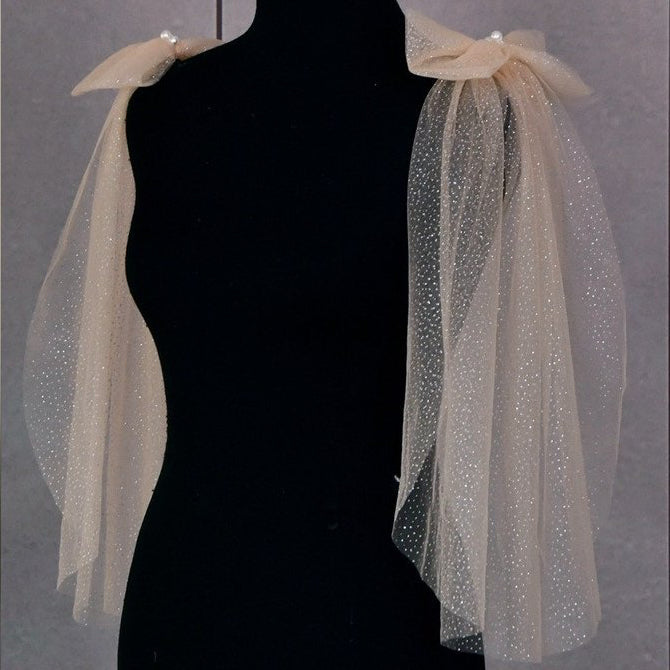Champagne glitter tulle shoulder bows with pearl cluster on dress form