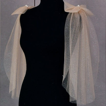 Champagne glitter tulle shoulder bows with pearl cluster on dress form