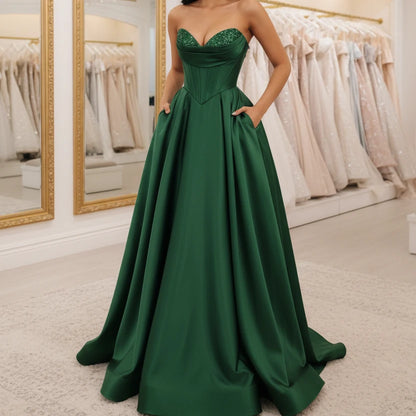 Emerald green strapless A-line satin dress with sequin bust and thigh-high slit