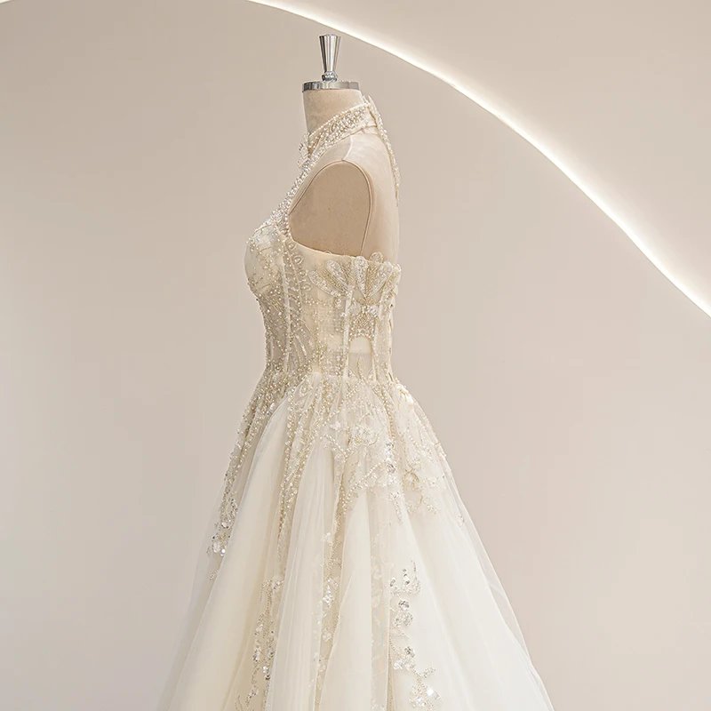 Ivory vintage wedding gown side view with embellished halter straps and flared tulle skirt