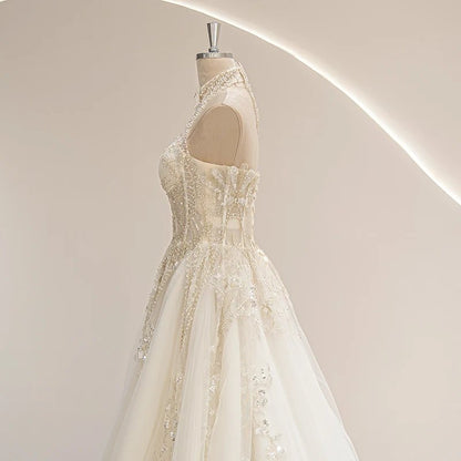 Ivory vintage wedding gown side view with embellished halter straps and flared tulle skirt