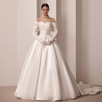 Ivory off-shoulder satin bridal gown with embroidered waist detail and A-line skirt