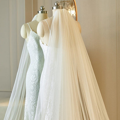 Ivory cathedral veil with lace-trimmed edge and soft tulle, gathered at top