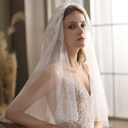 Ivory sheer blusher veil with lace trim, flowing side drape over shoulders