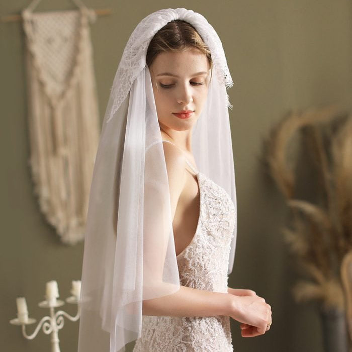 Ivory elbow-length blusher veil with lace trim, side drape down to arms