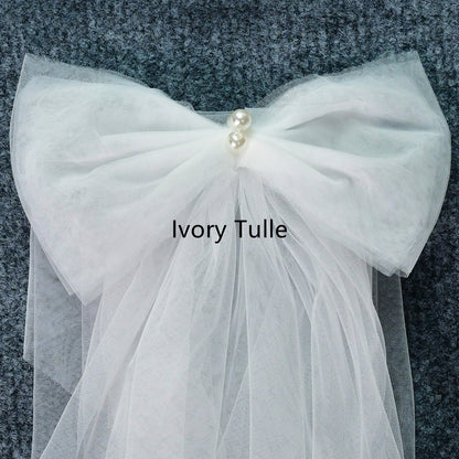 Ivory tulle shoulder bow with gathered net fabric and pearl center