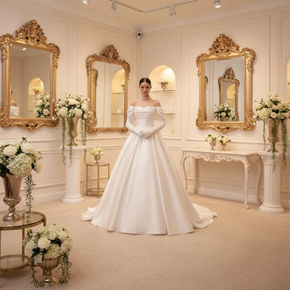 Ivory off-shoulder satin bridal gown with embellished corset bodice and full skirt