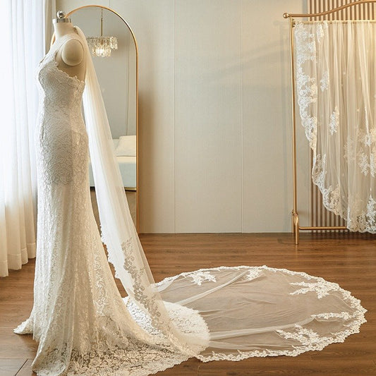 Ivory cathedral wedding veil with lace-edged single tier, flowing train