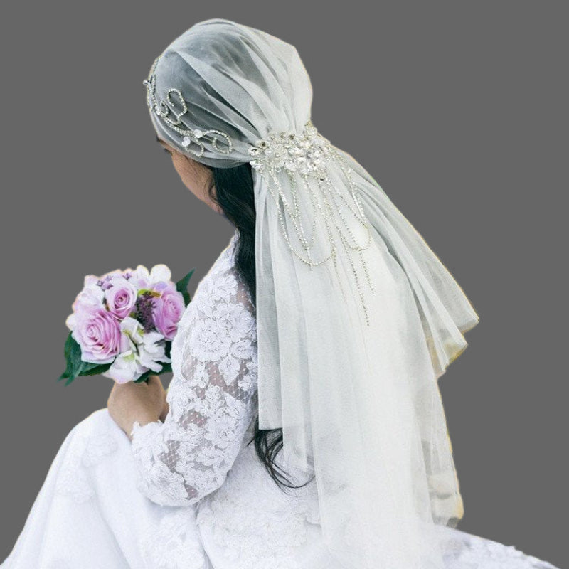 Ivory bridal veil with crystal-embellished cap and draping tulle, side rear view