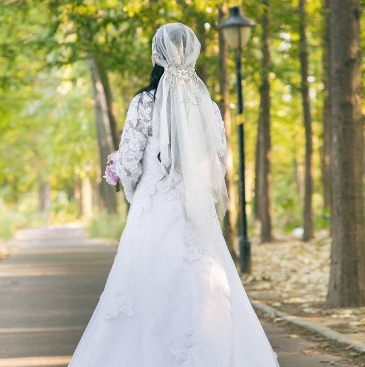 Ivory bridal veil with sheer cap and long flowing tulle train