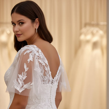 Ivory A-line lace wedding dress with V-neckline and floral appliqué on the bodice