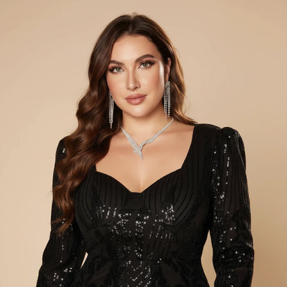 Black sequin mermaid evening gown, long sleeves, V-neck, fitted mermaid skirt.