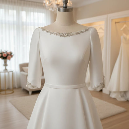 A-line satin wedding dress with scoop neckline and beaded sleeve cuffs, full front