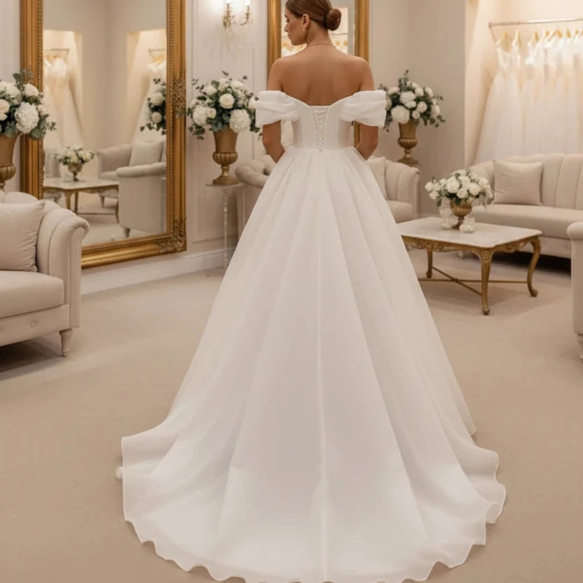 White off-shoulder corset bridal gown with off-shoulder sleeves and full A-line skirt