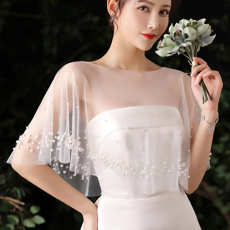 Ivory beaded bridal cape shrug with draped sheer sleeves and pearl bead accents