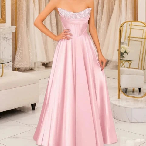 Blush pink strapless beaded satin A-line evening gown with sparkling neckline